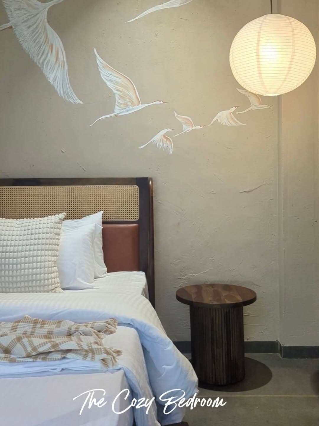 Cozy bedroom with crane mural